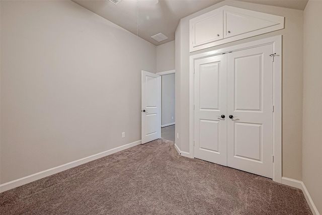 unfurnished bedroom with carpet floors and a closet