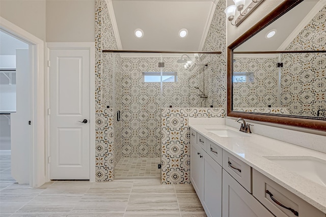 bathroom with vanity, crown molding, and a shower with shower door