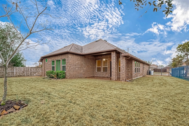 view of side of home with a lawn