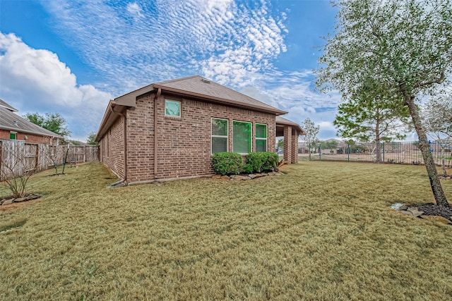 back of house with a lawn