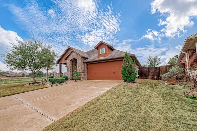 view of front of house featuring a garage and a front lawn