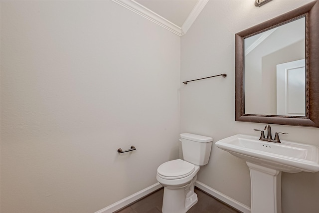 bathroom with ornamental molding and toilet