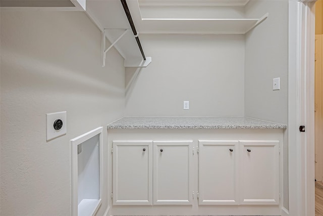 washroom with cabinets and electric dryer hookup