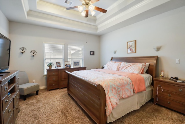 carpeted bedroom featuring ornamental molding, ceiling fan, and a tray ceiling