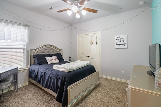 bedroom featuring a closet, carpet flooring, and multiple windows