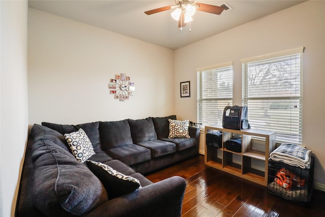 living room with dark wood-type flooring and ceiling fan