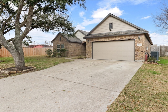 ranch-style house featuring a garage, a front yard, and central AC unit