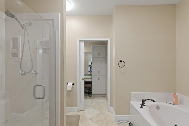 bathroom with independent shower and bath, tile patterned floors, and a textured ceiling