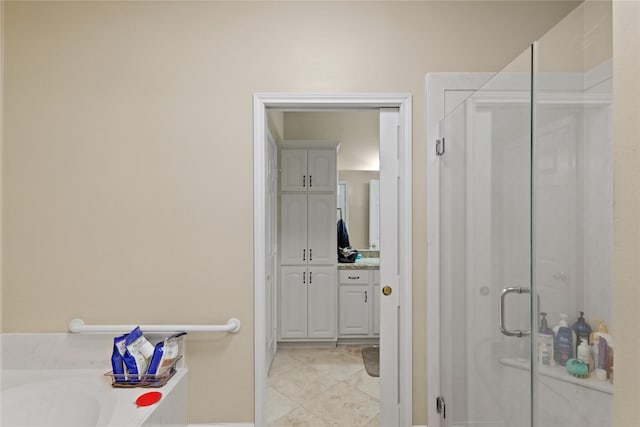 bathroom featuring tile patterned floors, vanity, and shower with separate bathtub