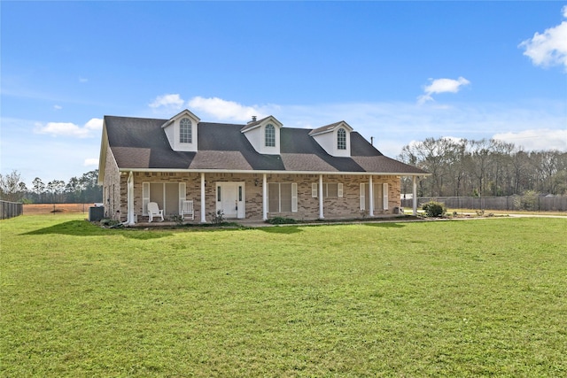 cape cod home featuring a porch and a front lawn