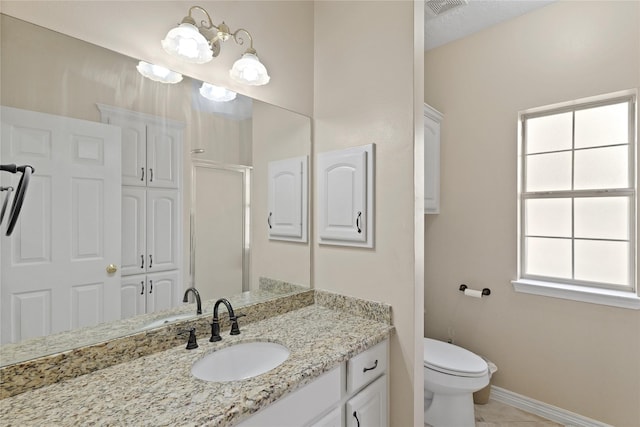 bathroom with vanity, tile patterned floors, and toilet