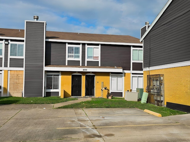 back of house featuring brick siding