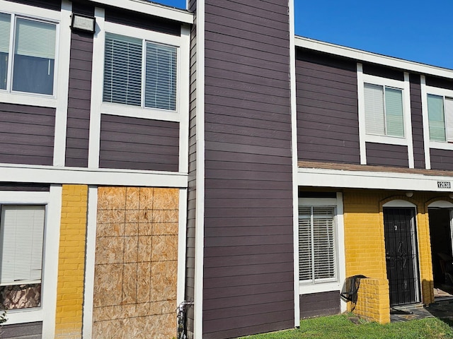 view of side of property with brick siding