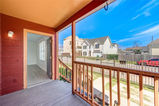 deck featuring fence and a residential view