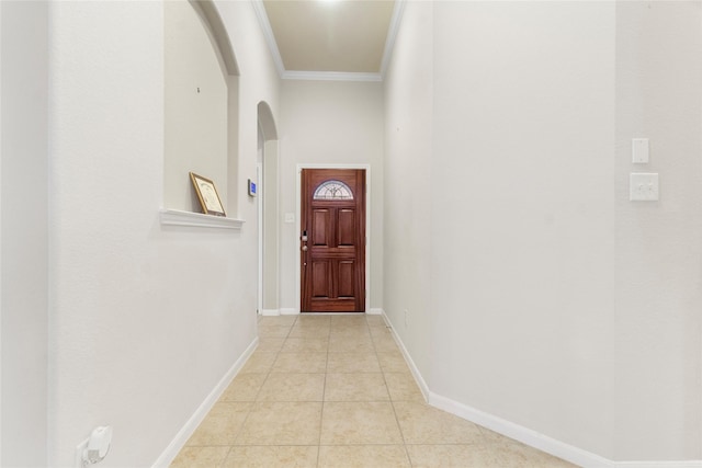 doorway with light tile patterned floors and ornamental molding