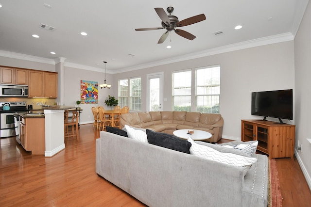 living room featuring sink, ornamental molding, and light hardwood / wood-style floors