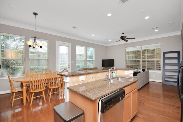 kitchen featuring sink, light hardwood / wood-style flooring, dishwasher, light stone countertops, and a kitchen island with sink