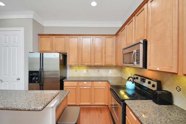 kitchen with ornamental molding, appliances with stainless steel finishes, light stone countertops, and light hardwood / wood-style flooring