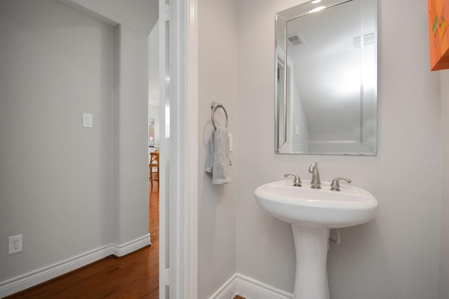 bathroom with hardwood / wood-style floors and sink