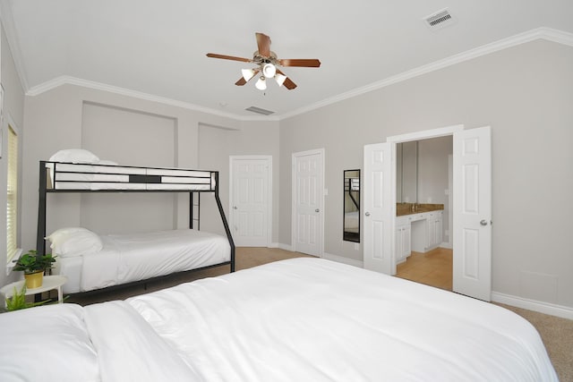 bedroom with crown molding, light carpet, ceiling fan, and ensuite bathroom