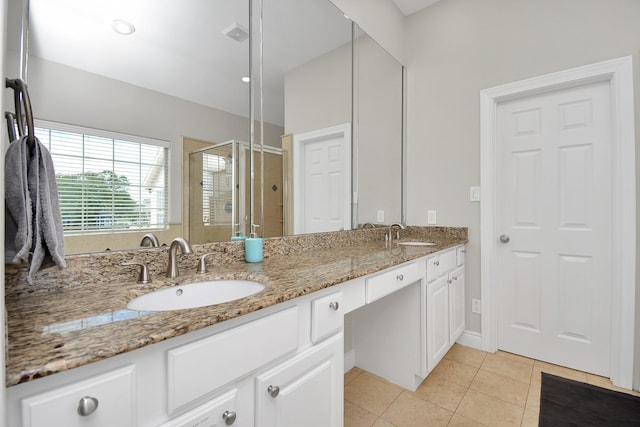 bathroom featuring walk in shower, tile patterned floors, and vanity