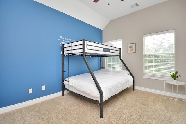 unfurnished bedroom featuring vaulted ceiling, carpet flooring, and ceiling fan