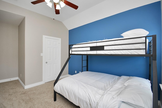 bedroom with lofted ceiling, ceiling fan, and carpet