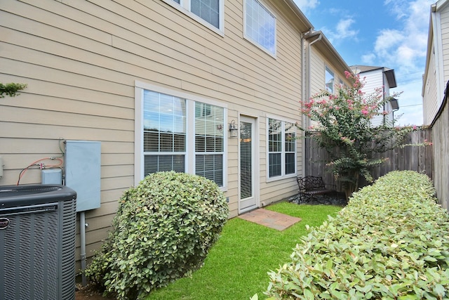 view of side of home with central AC