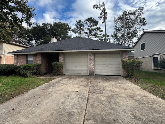 single story home with a garage and a front lawn