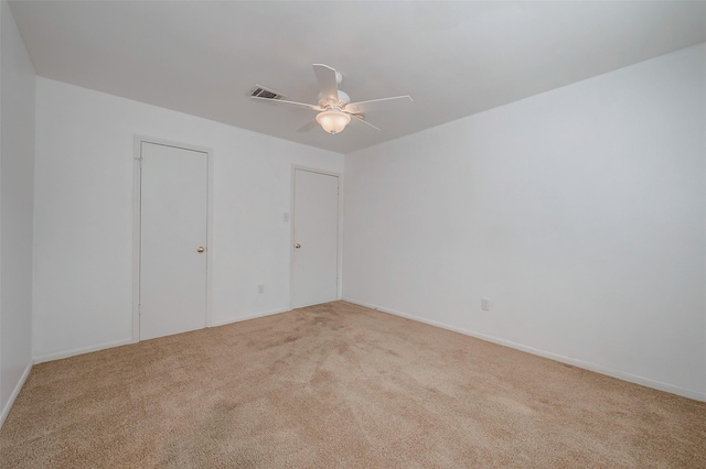 unfurnished bedroom with ceiling fan and light colored carpet