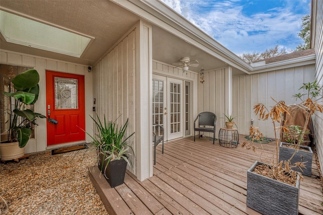 doorway to property featuring a deck, ceiling fan, and french doors