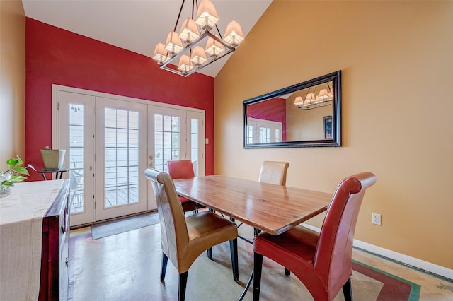 dining room featuring lofted ceiling, a notable chandelier, and french doors