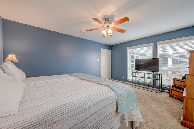 bedroom featuring light colored carpet and ceiling fan