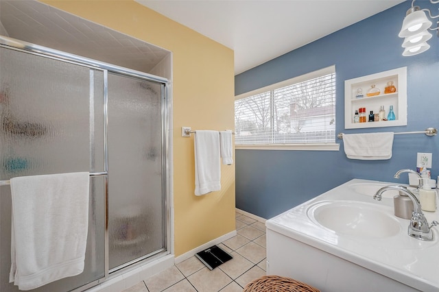 bathroom featuring sink, an enclosed shower, and tile patterned flooring