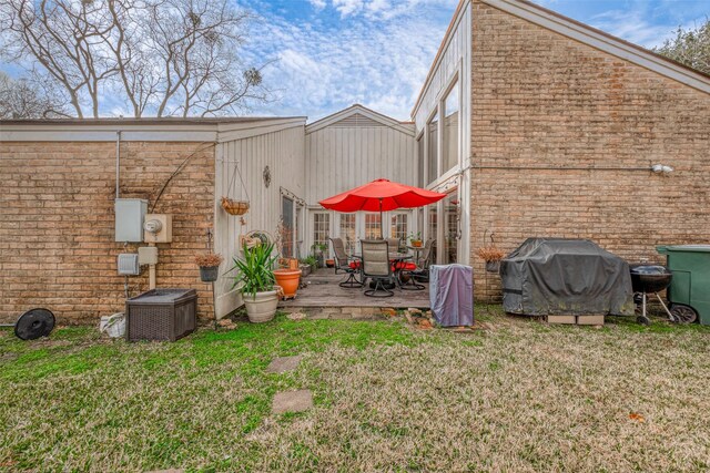 rear view of house featuring a patio and a yard