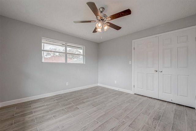 unfurnished bedroom featuring ceiling fan and a closet