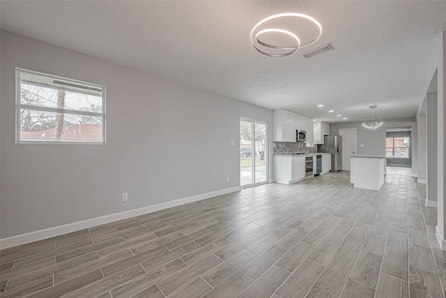 unfurnished living room with a textured ceiling