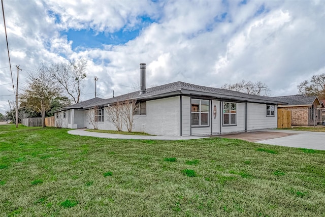 back of property featuring a patio and a lawn