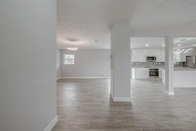 unfurnished living room featuring a textured ceiling