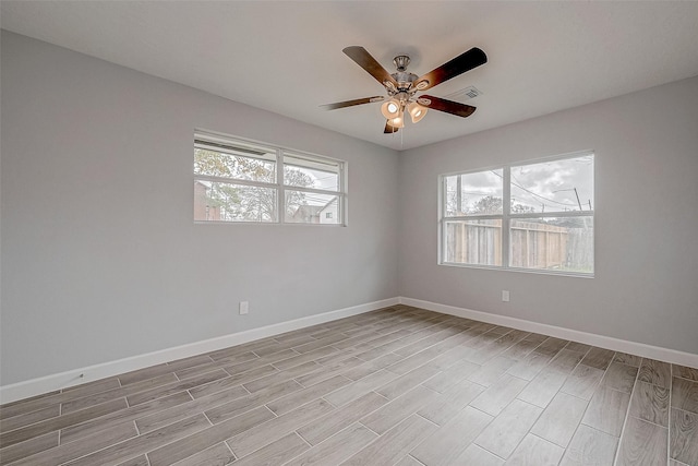 empty room featuring light hardwood / wood-style flooring and ceiling fan