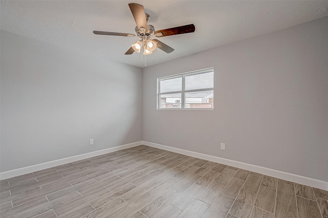 empty room featuring ceiling fan and light wood-type flooring