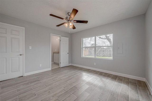 unfurnished bedroom with ensuite bathroom, ceiling fan, and light wood-type flooring