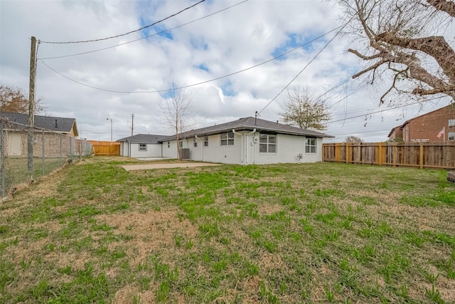 rear view of property with a yard and a patio area