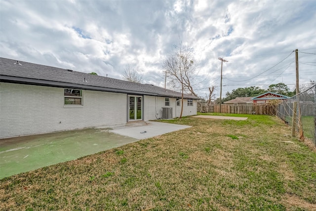 view of yard featuring central AC unit and a patio