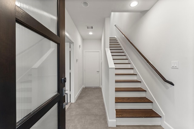 stairway featuring tile patterned floors