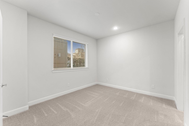 spare room with light colored carpet