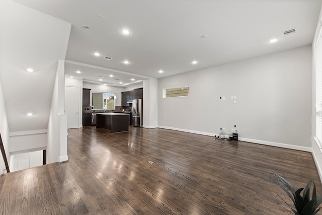 unfurnished living room with dark wood-type flooring