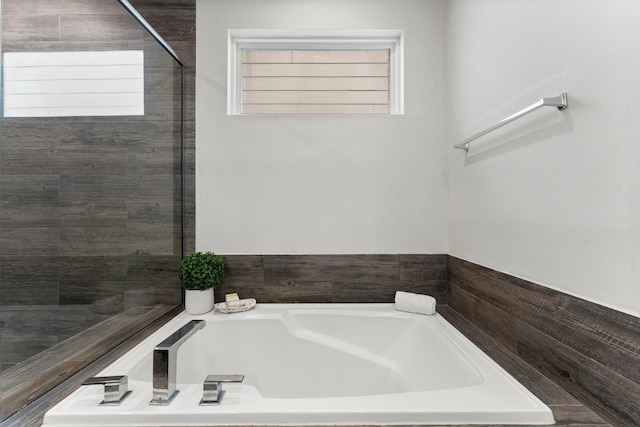 bathroom featuring tiled bath