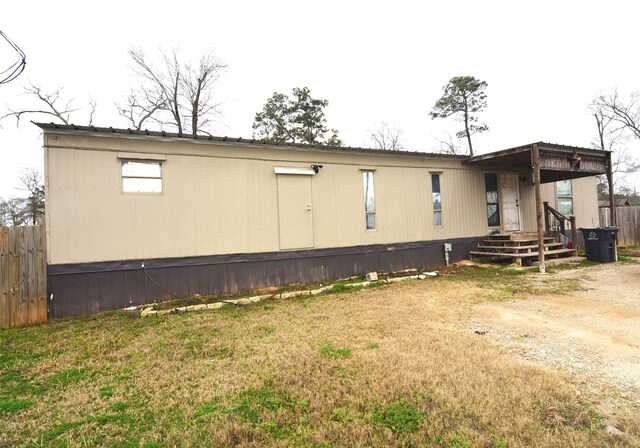 view of side of home with a yard