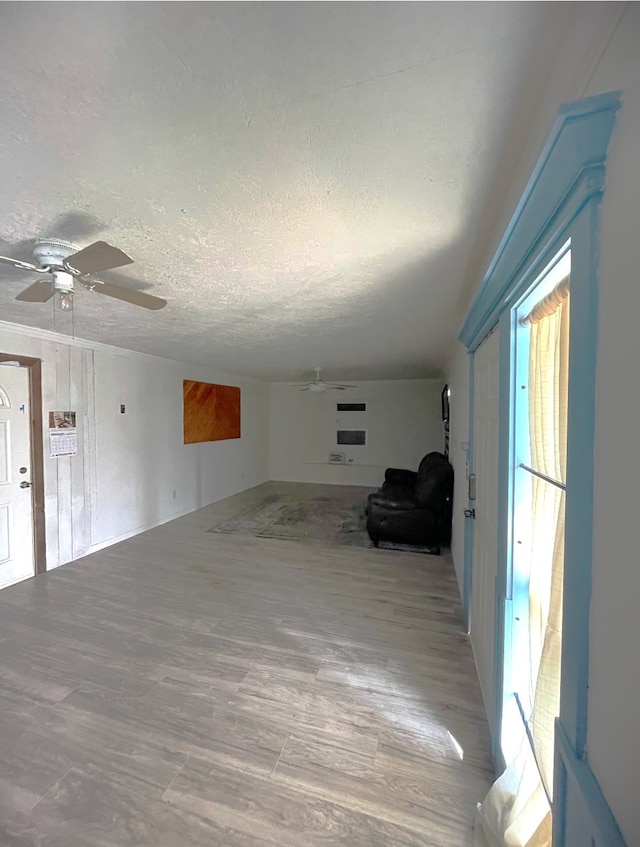 empty room featuring hardwood / wood-style flooring, ceiling fan, and a textured ceiling